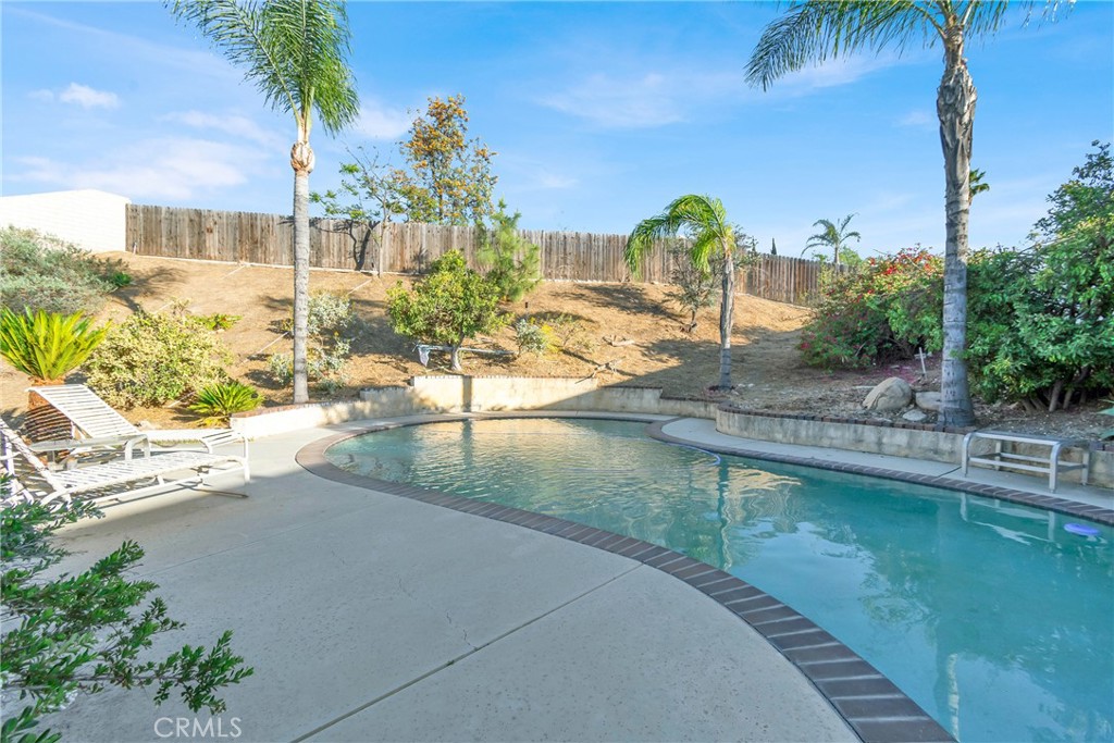 3350 May Court Riverside, CA 92503 - Photo 49 of 55 a view of a swimming pool with a lawn chairs under an umbrella