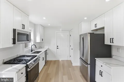 a kitchen with stainless steel appliances a refrigerator stove and sink