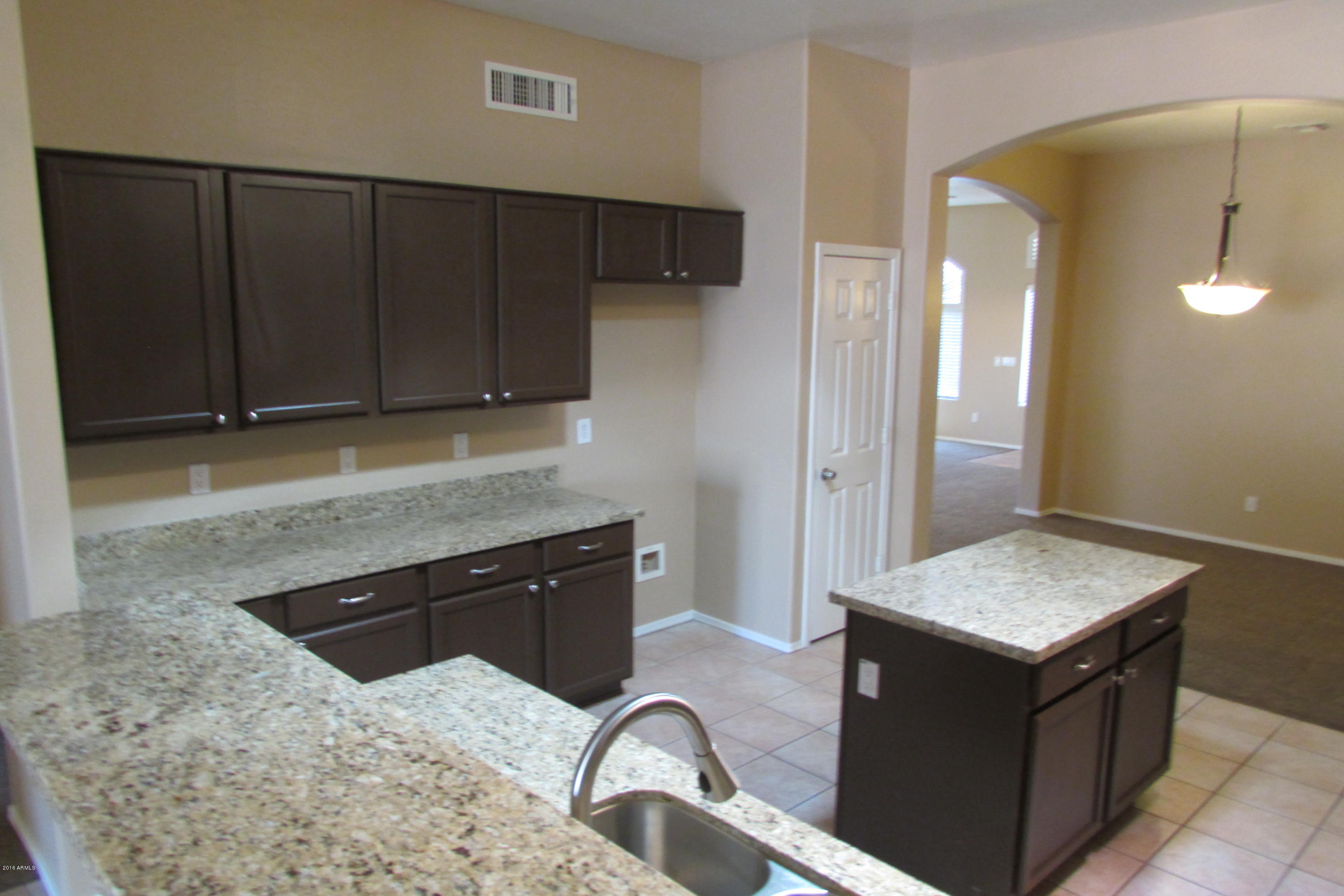 716 East Ranch Road Gilbert, AZ 85296 - Photo 8 of 22 a kitchen with granite countertop a sink a stove and cabinets
