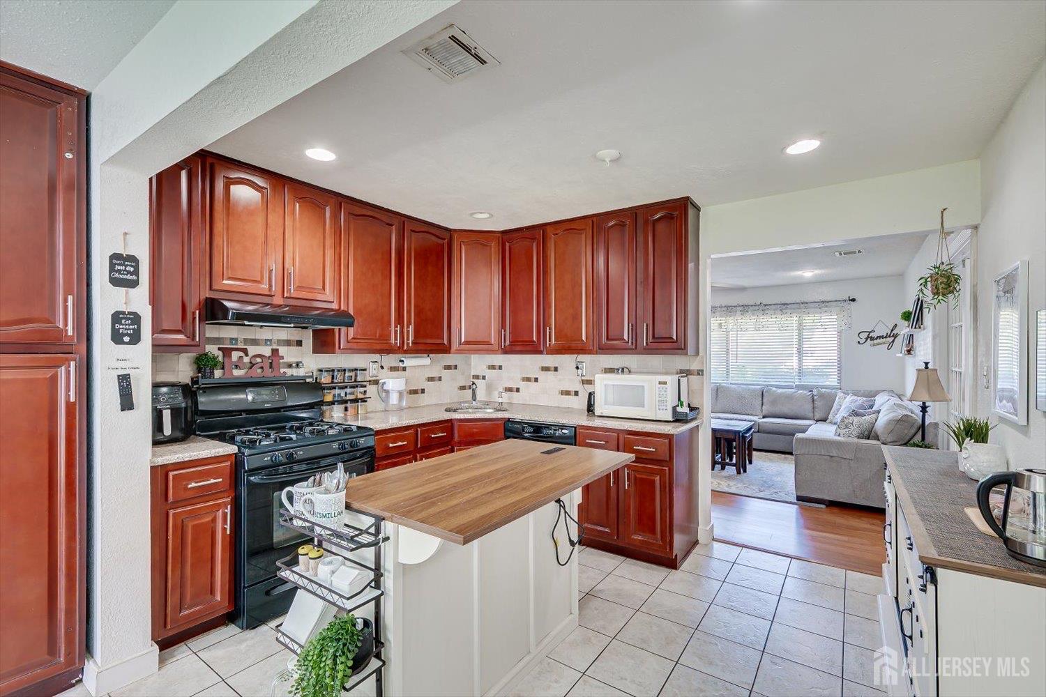 15 Markham Road Edison, NJ 08817 - Photo 11 of 32 a kitchen with a stove a sink and a refrigerator