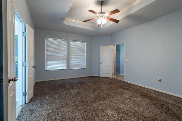 a bathroom with a granite countertop sink a mirror and a wooden cabinets