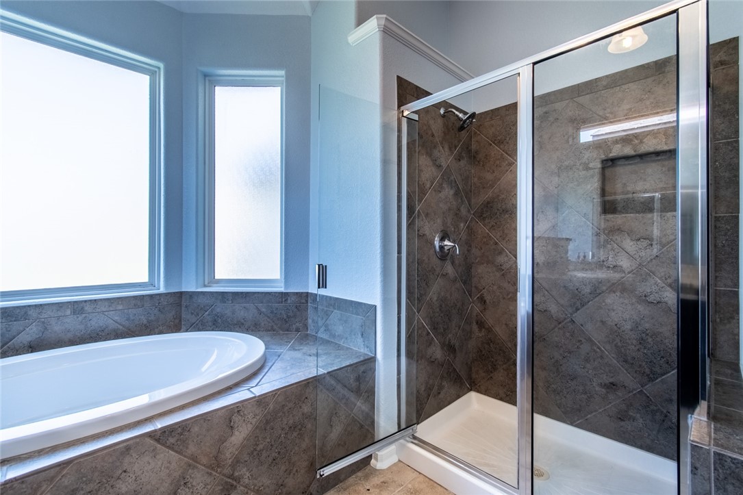 316 San Jose Street Portland, TX 78374 - Photo 20 of 35 a bathroom with a bathtub and a shower