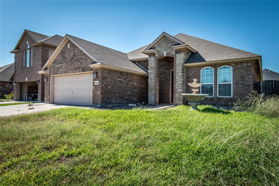 316 San Jose Street Portland, TX 78374 - Photo 2 of 35 a front view of a house with a garden
