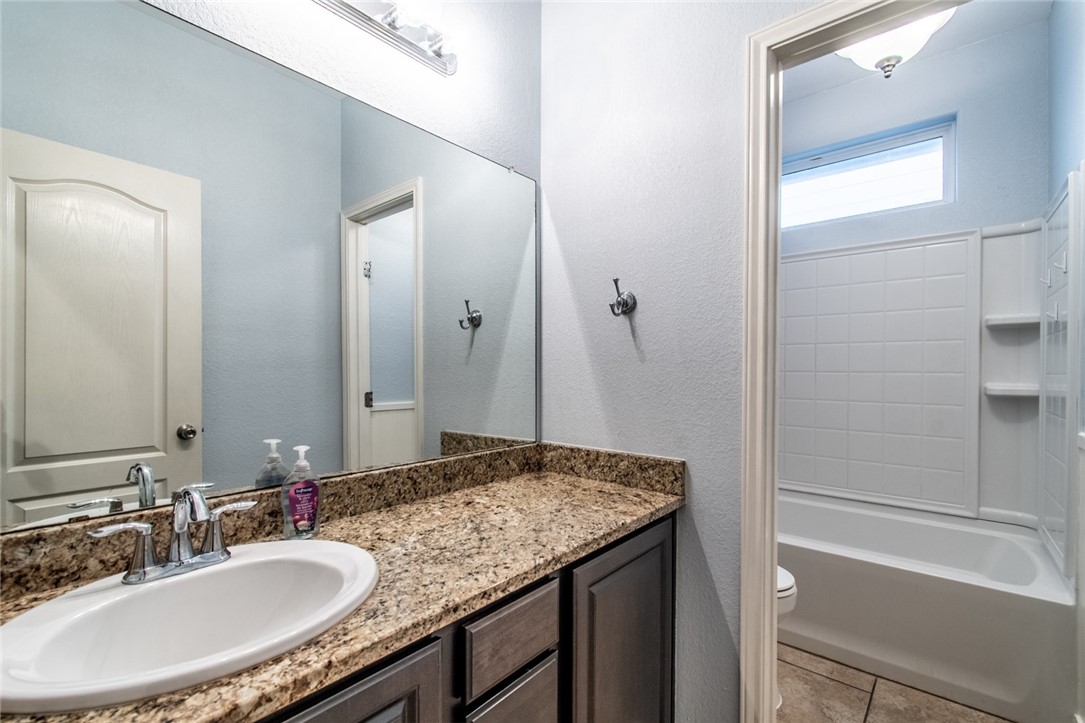 316 San Jose Street Portland, TX 78374 - Photo 23 of 35 a bathroom with a granite countertop sink and a mirror