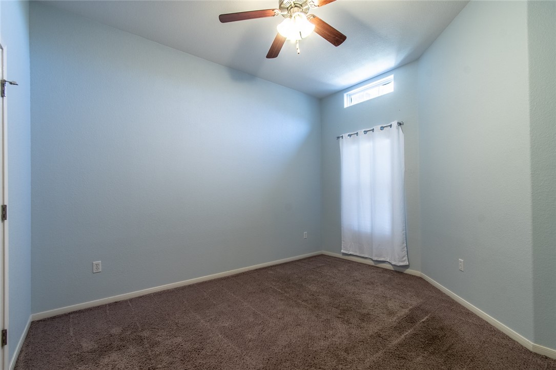 316 San Jose Street Portland, TX 78374 - Photo 28 of 35 an empty room with a chandelier fan and windows