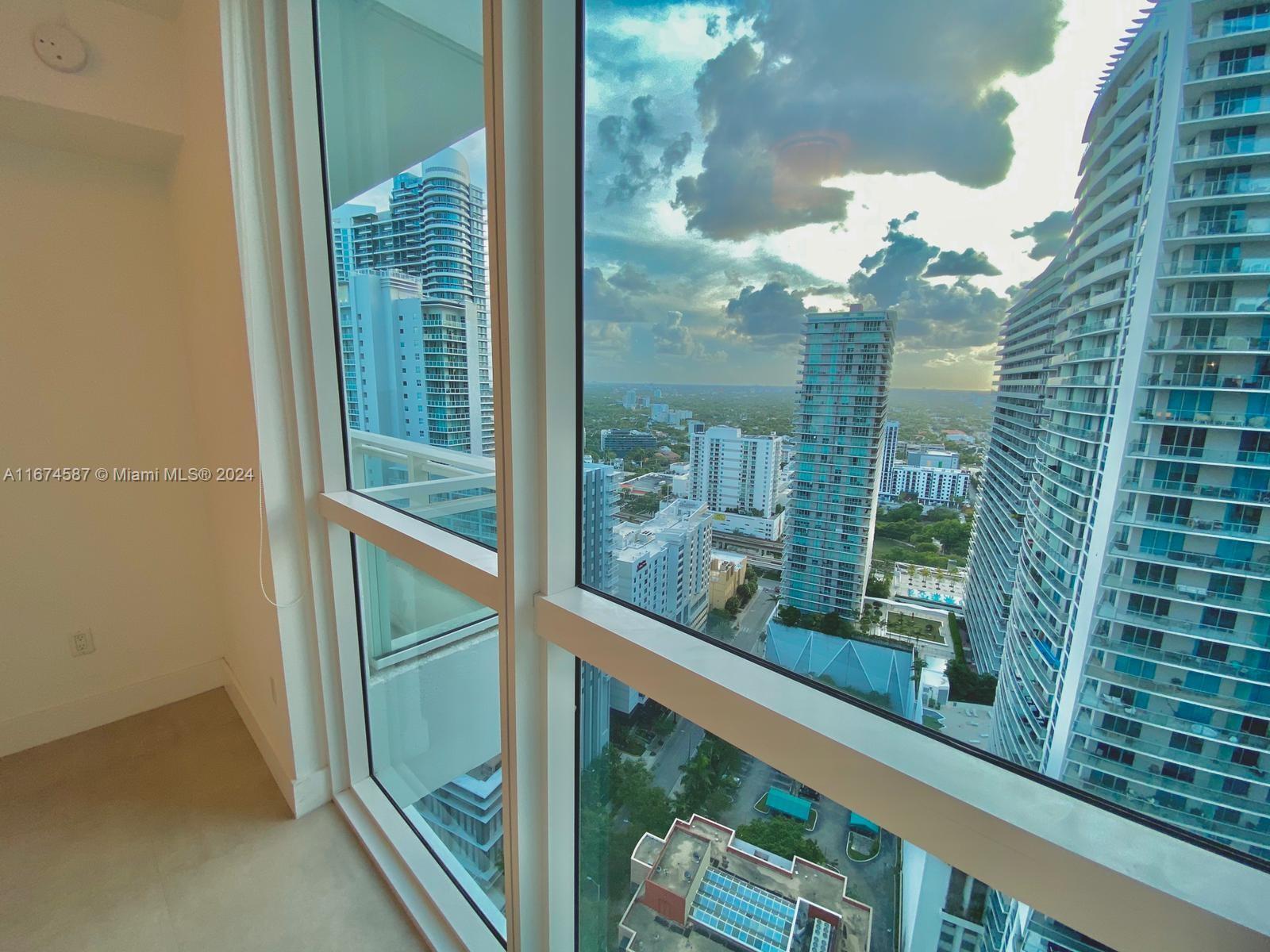 1080 Brickell Avenue, Unit 3107 Miami, FL 33131 - Photo 11 of 19 a view of a glass door and a window