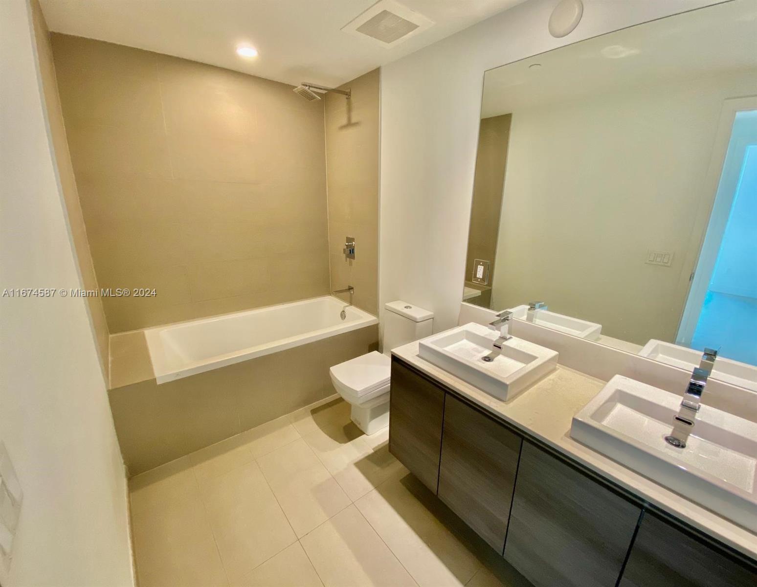 1080 Brickell Avenue, Unit 3107 Miami, FL 33131 - Photo 14 of 19 a bathroom with a sink a toilet and tub