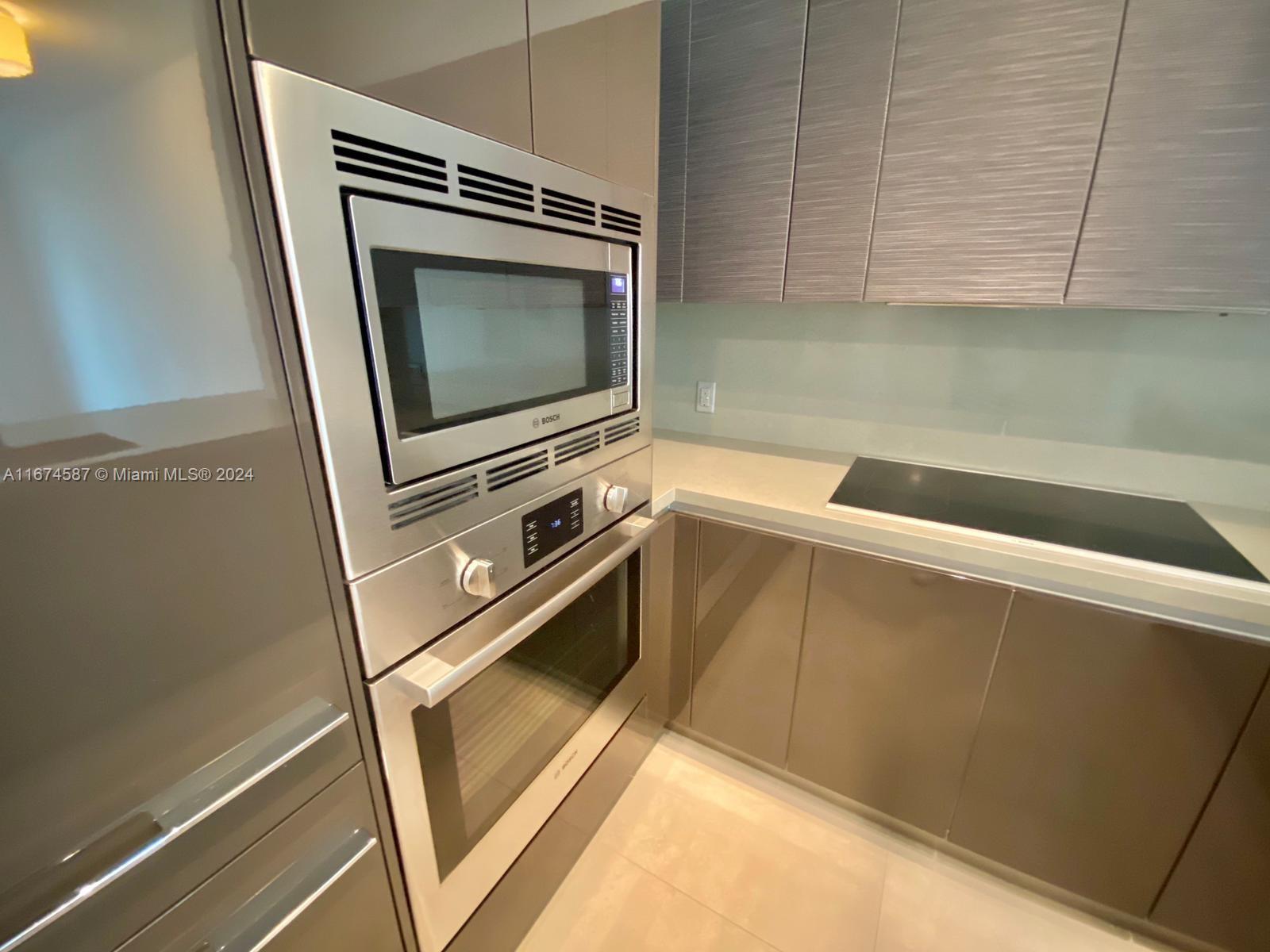 1080 Brickell Avenue, Unit 3107 Miami, FL 33131 - Photo 16 of 19 a view of a microwave and an outdoor space in the kitchen