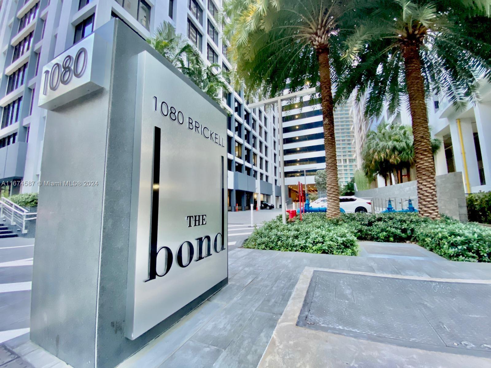 1080 Brickell Avenue, Unit 3107 Miami, FL 33131 - Photo 19 of 19 a front view of multi story residential apartment building with yard and sign board