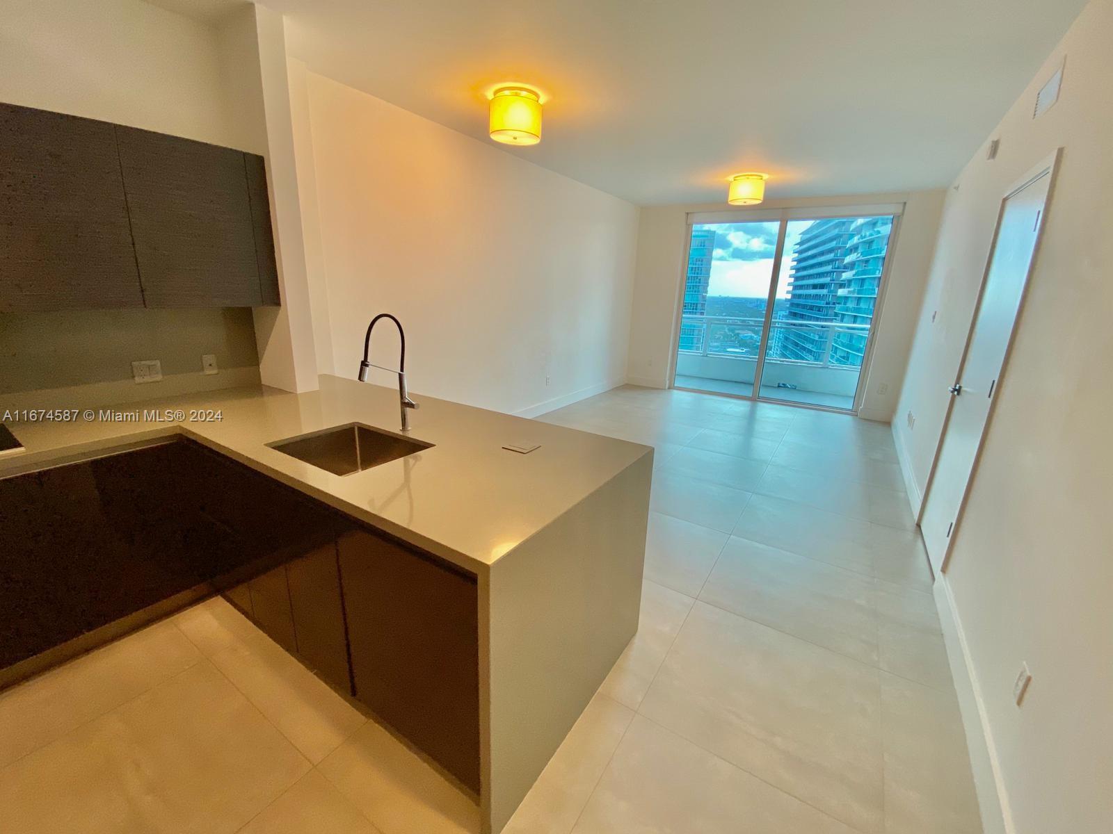 1080 Brickell Avenue, Unit 3107 Miami, FL 33131 - Photo 7 of 19 a kitchen with a sink and cabinets