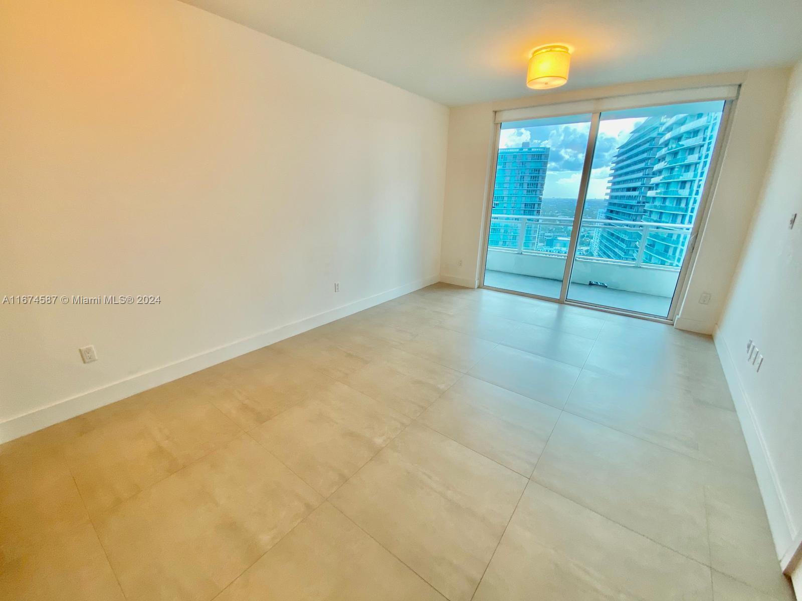 1080 Brickell Avenue, Unit 3107 Miami, FL 33131 - Photo 8 of 19 an empty room with windows