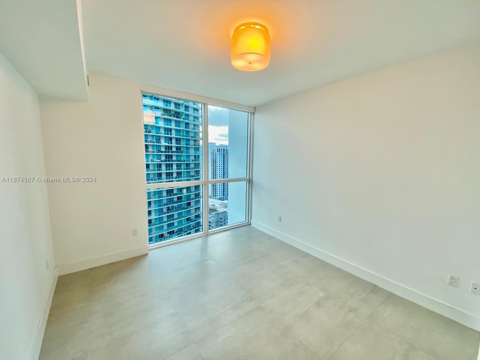 1080 Brickell Avenue, Unit 3107 Miami, FL 33131 - Photo 10 of 19 an empty room with windows
