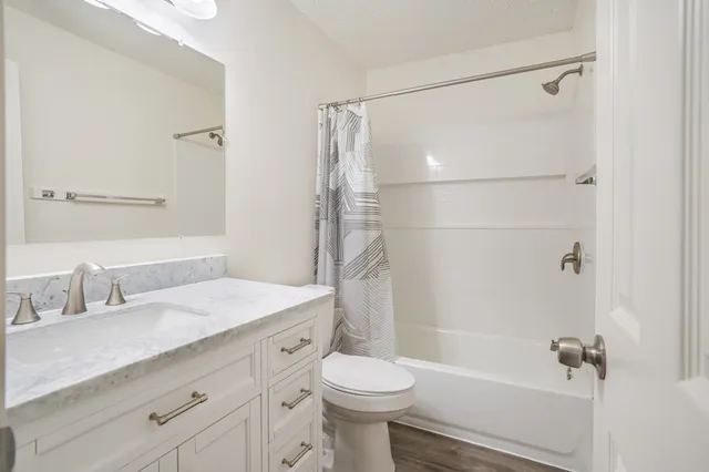 a bathroom with a sink toilet and shower