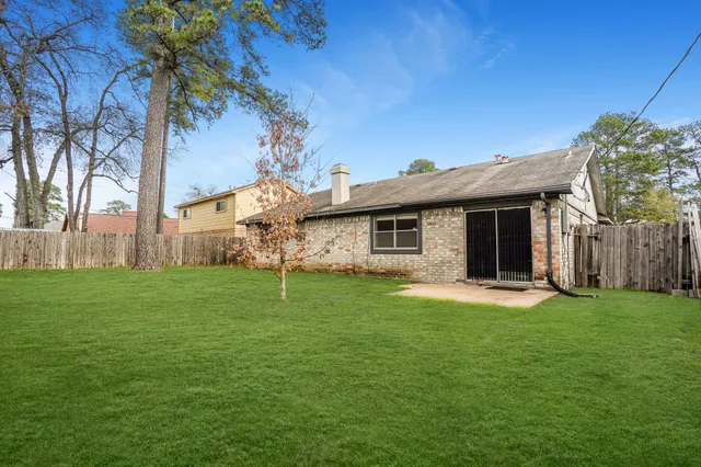 a backyard of a house with table and chairs