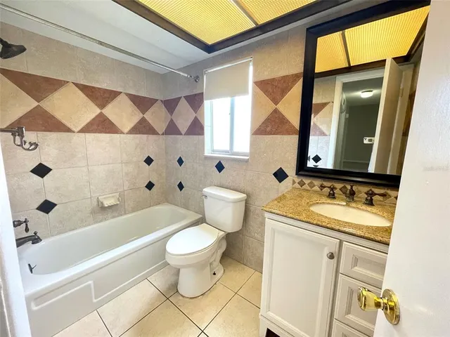 a white toilet sitting next to a bathroom sink