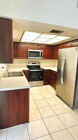 a kitchen with a stove a sink and a microwave