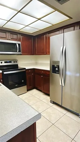 a kitchen with stainless steel appliances a stove a refrigerator and a sink