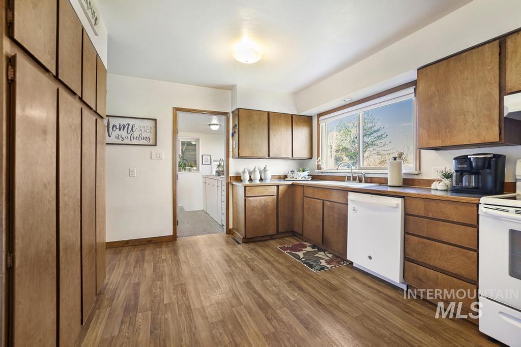 3985 North 2300 E Road Filer, ID 83328 - Photo 11 of 35 Kitchen with white appliances, wood finish cabinets, and dark wood finished floors