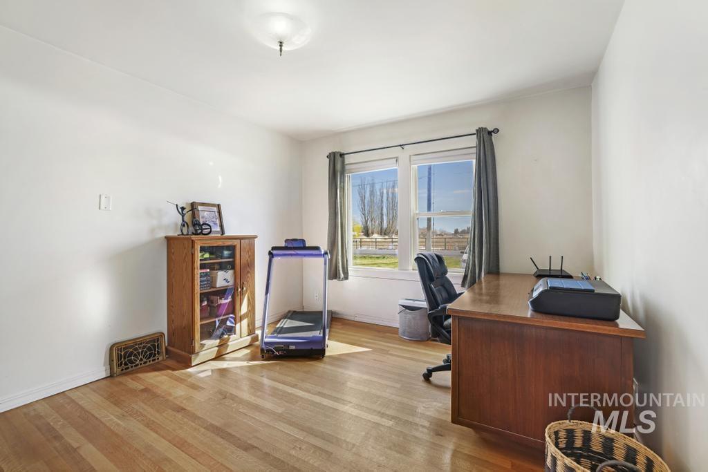 3985 North 2300 E Road Filer, ID 83328 - Photo 15 of 35 Home office featuring light wood-style flooring and baseboards
