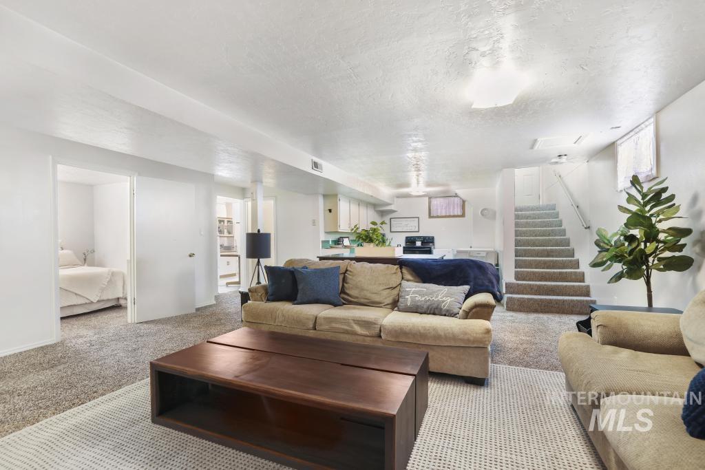 3985 North 2300 E Road Filer, ID 83328 - Photo 19 of 35 Living area with carpet flooring and a textured ceiling