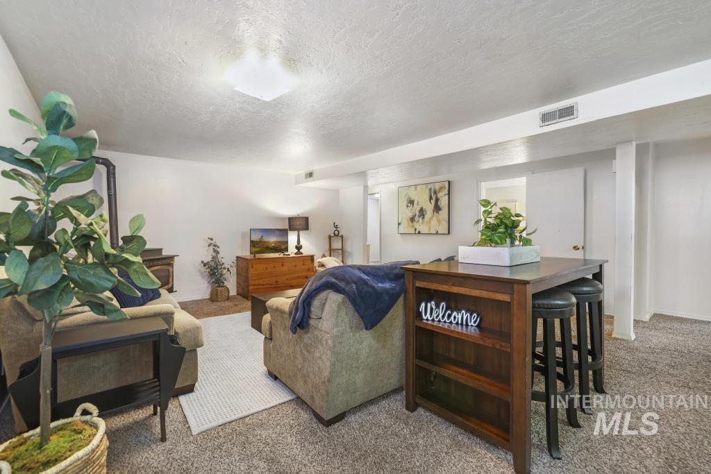 3985 North 2300 E Road Filer, ID 83328 - Photo 21 of 35 Carpeted living room featuring a textured ceiling