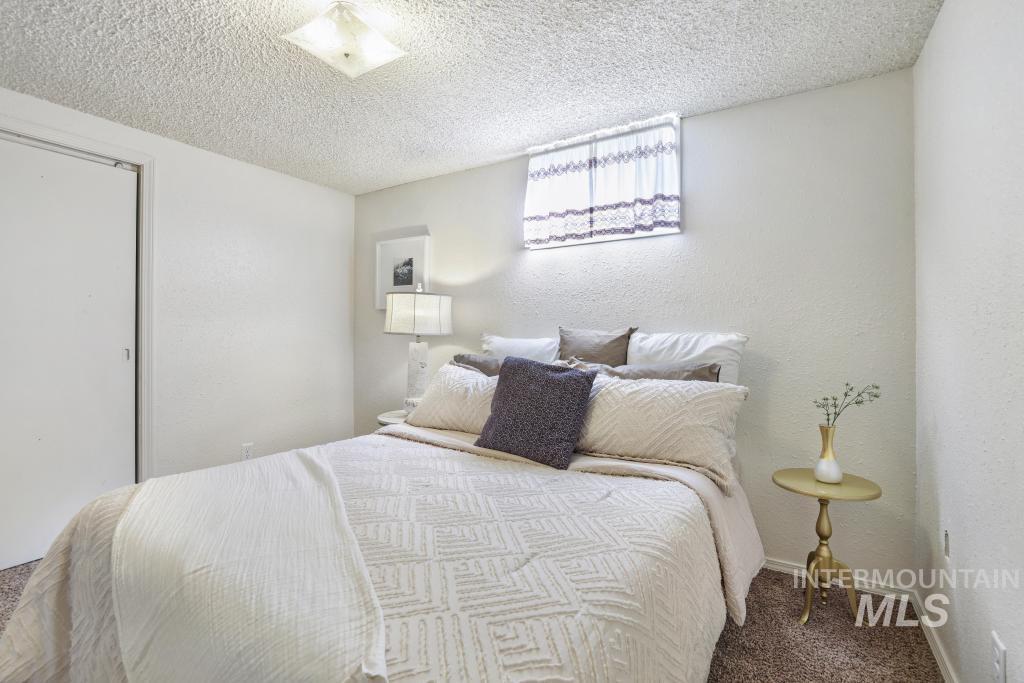 3985 North 2300 E Road Filer, ID 83328 - Photo 23 of 35 Carpeted bedroom with a textured wall and a textured ceiling