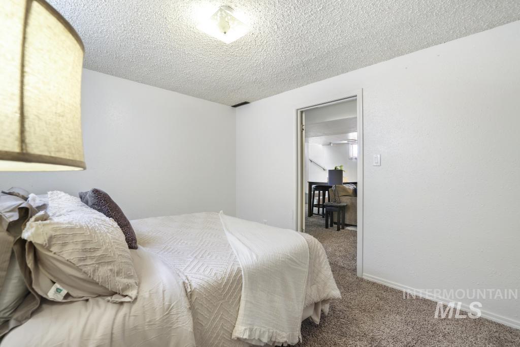 3985 North 2300 E Road Filer, ID 83328 - Photo 24 of 35 Carpeted bedroom featuring a textured ceiling and baseboards