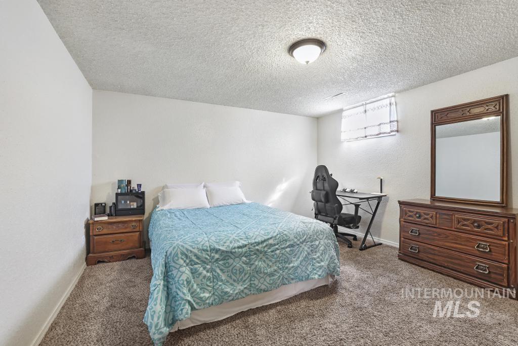 3985 North 2300 E Road Filer, ID 83328 - Photo 26 of 35 Carpeted bedroom with a textured ceiling and a textured wall