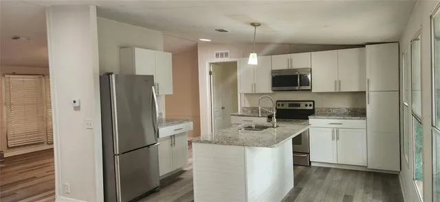 a kitchen with a refrigerator stove and microwave
