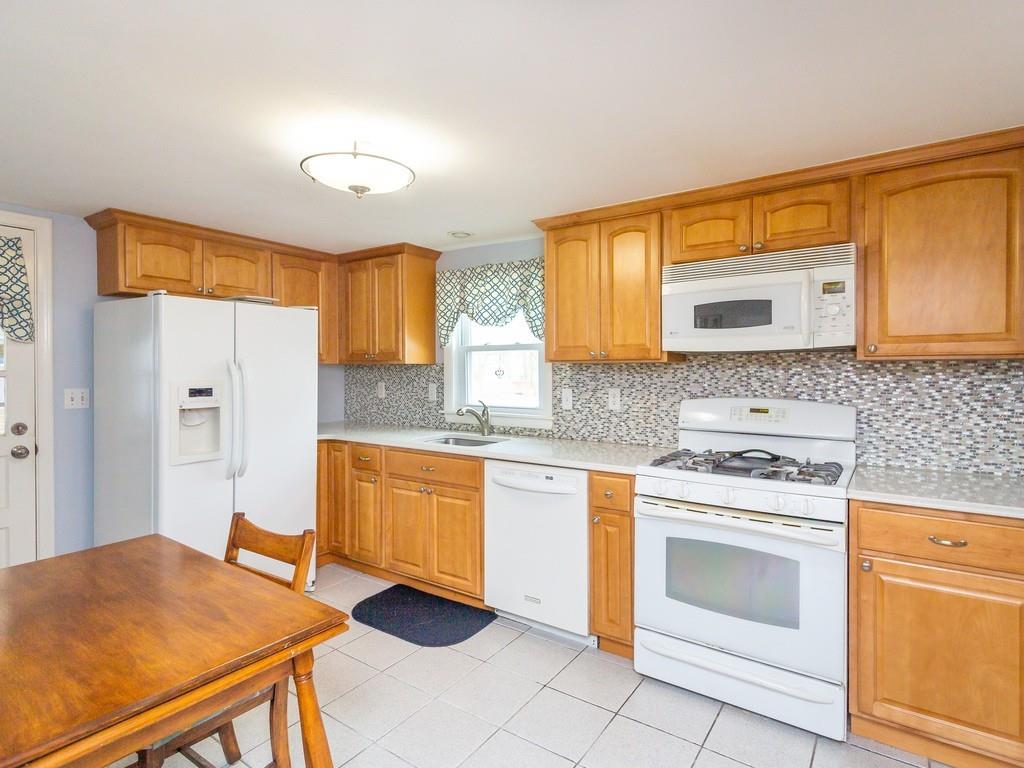 48 MacDonald Circle Walpole, MA 02081 - Photo 14 of 41 a kitchen with stainless steel appliances granite countertop a stove a sink and a refrigerator
