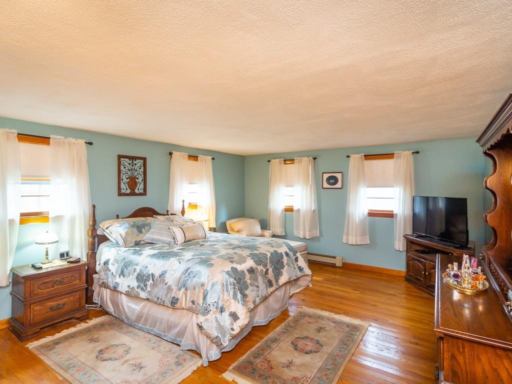 48 MacDonald Circle Walpole, MA 02081 - Photo 15 of 41 a bedroom with a bed and wooden floor