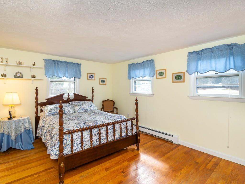 48 MacDonald Circle Walpole, MA 02081 - Photo 18 of 41 a bedroom with a bed and wooden floor