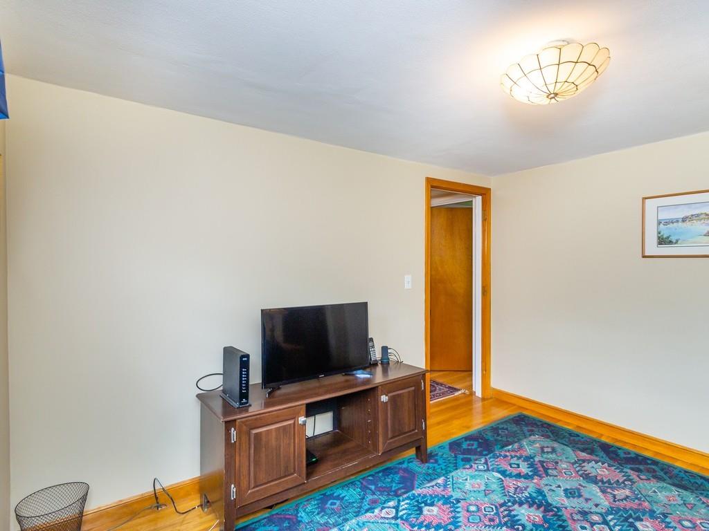 48 MacDonald Circle Walpole, MA 02081 - Photo 23 of 41 a living room with furniture and a flat screen tv
