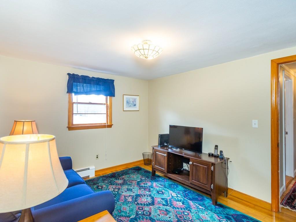 48 MacDonald Circle Walpole, MA 02081 - Photo 24 of 41 a living room with furniture and a flat screen tv