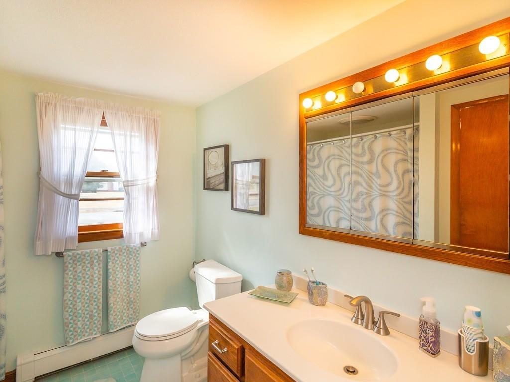 48 MacDonald Circle Walpole, MA 02081 - Photo 29 of 41 a bathroom with a sink mirror and a toilet