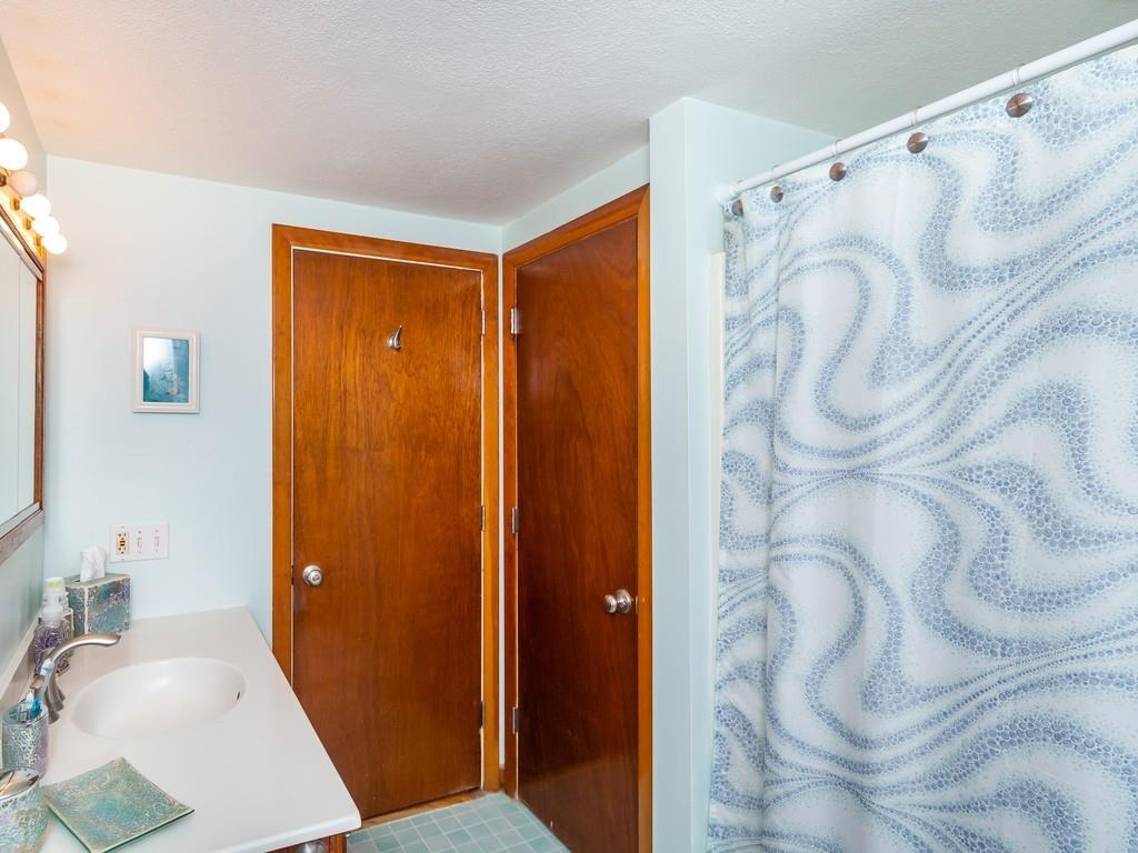48 MacDonald Circle Walpole, MA 02081 - Photo 30 of 41 a bathroom with a shower curtain and a sink
