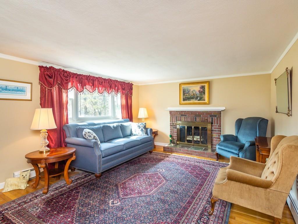 48 MacDonald Circle Walpole, MA 02081 - Photo 5 of 41 a living room with furniture and a fireplace