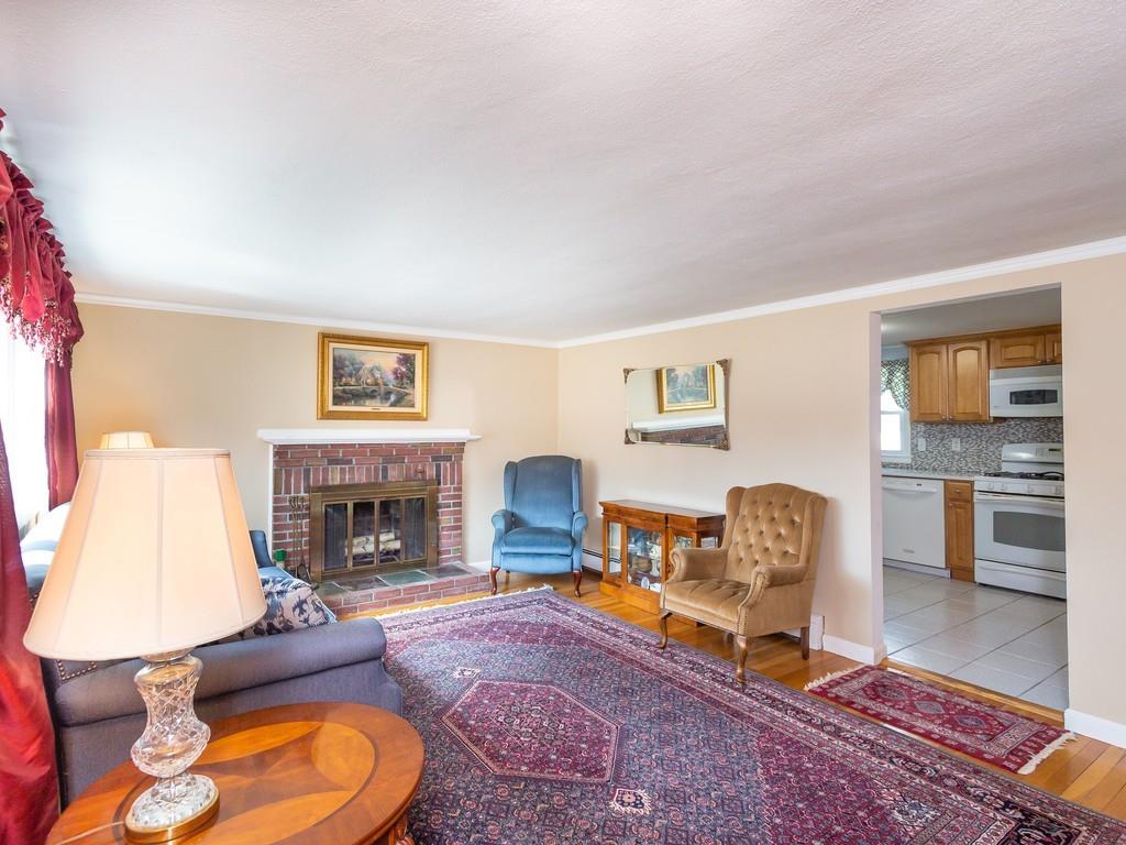 48 MacDonald Circle Walpole, MA 02081 - Photo 6 of 41 a living room with furniture and a fireplace