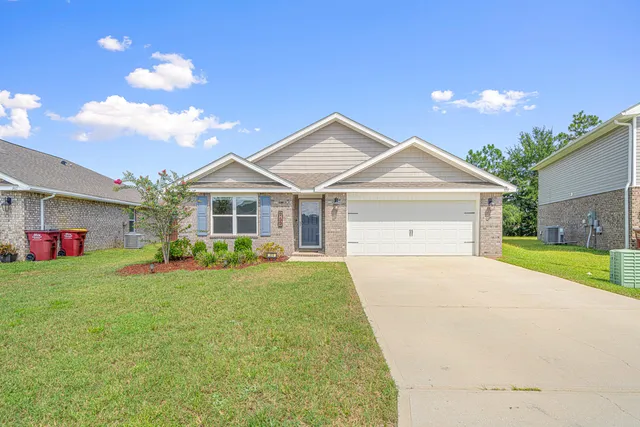 a front view of a house with swing and chairs