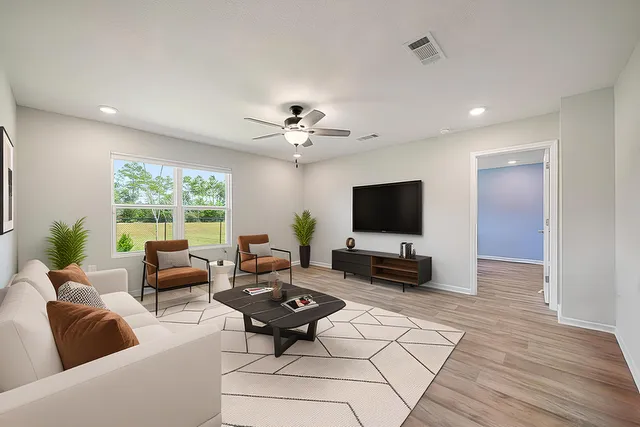 a living room with furniture and a flat screen tv