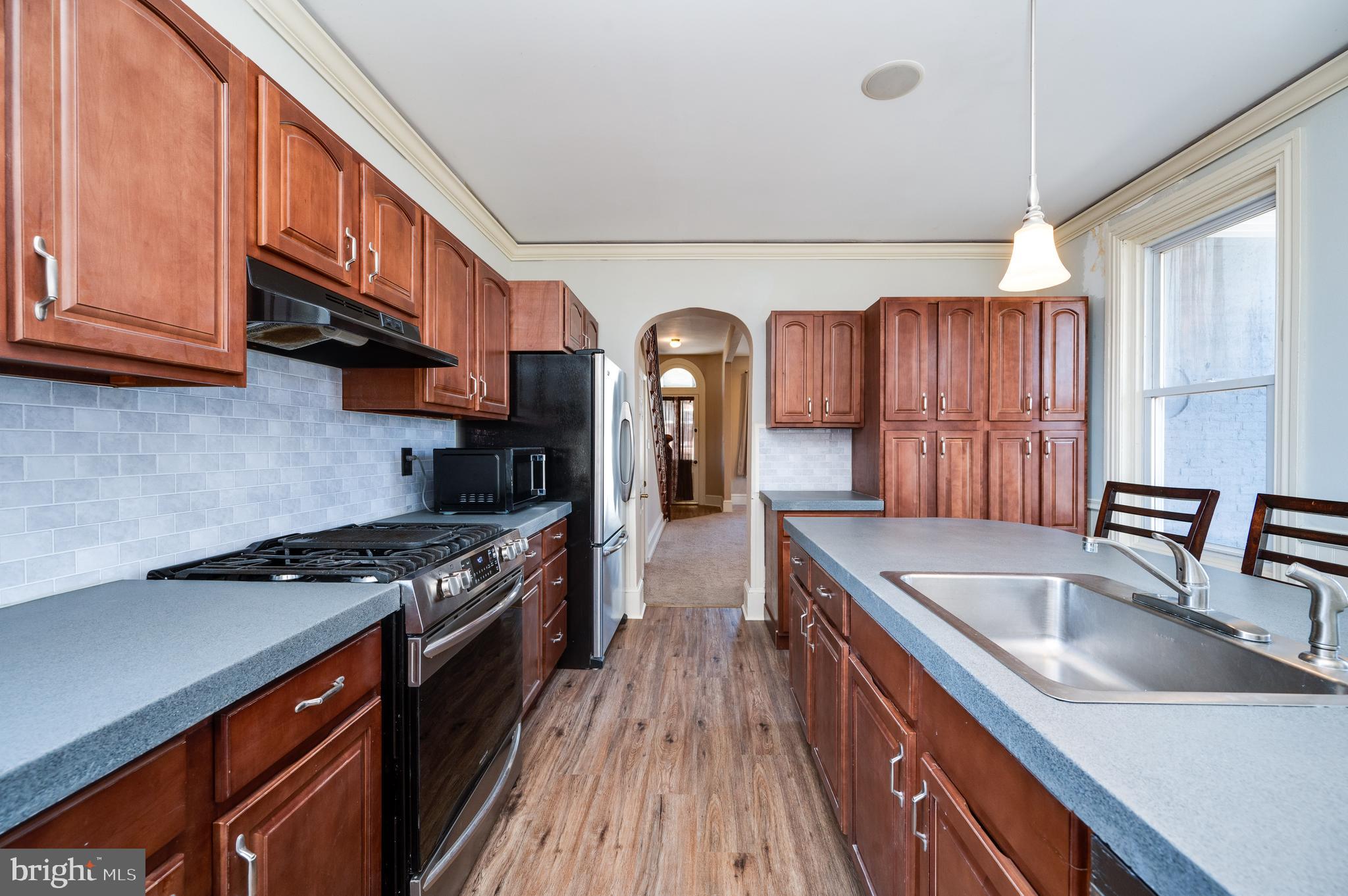 800 Mount Laurel Road Temple, PA 19560 - Photo 17 of 42 a kitchen with granite countertop stainless steel appliances a sink a stove cabinets counter space and a window