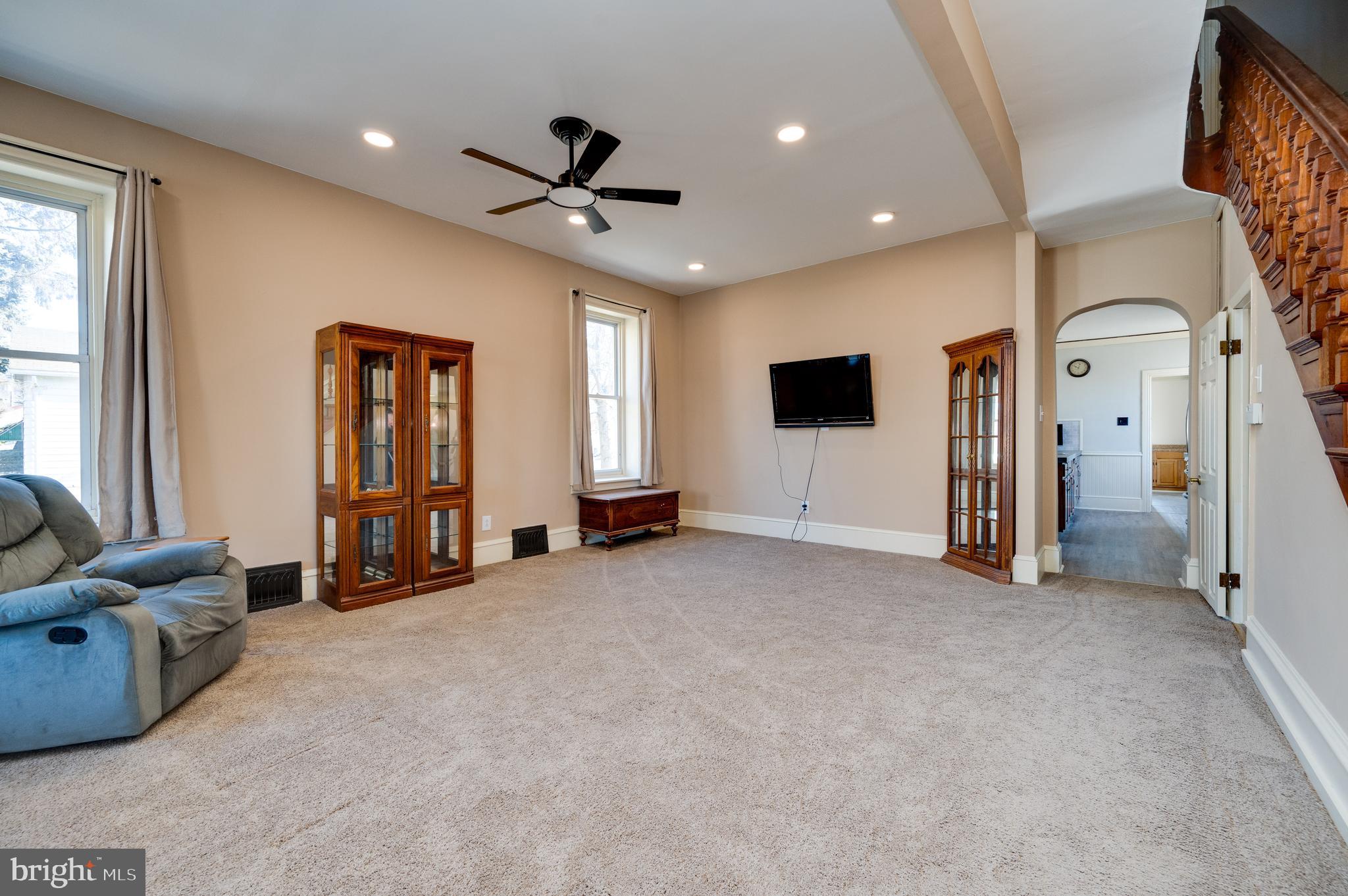800 Mount Laurel Road Temple, PA 19560 - Photo 9 of 42 a view of a livingroom with a flat screen tv ceiling fan and windows