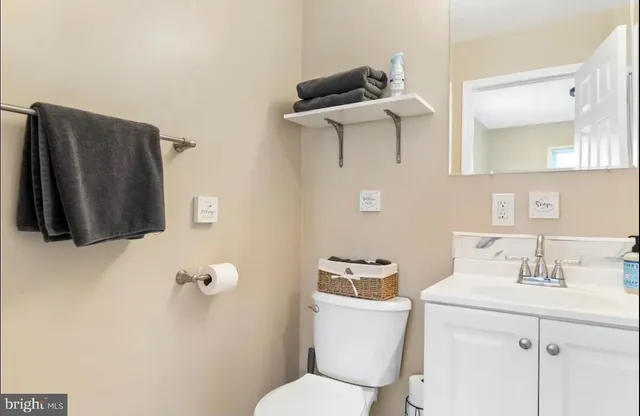 a bathroom with a toilet sink and mirror