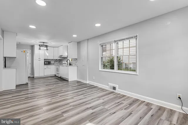 a view of kitchen with wooden floor and window