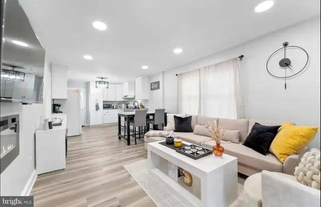 a living room with furniture and kitchen view