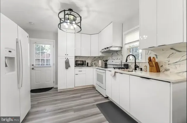 a kitchen with cabinets a sink and stainless steel appliances