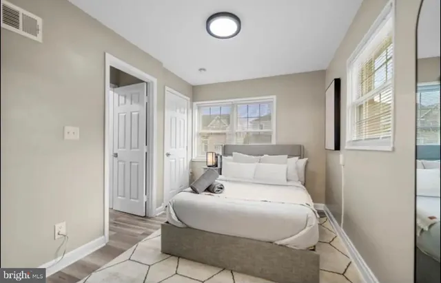 a bedroom with a bed and a window