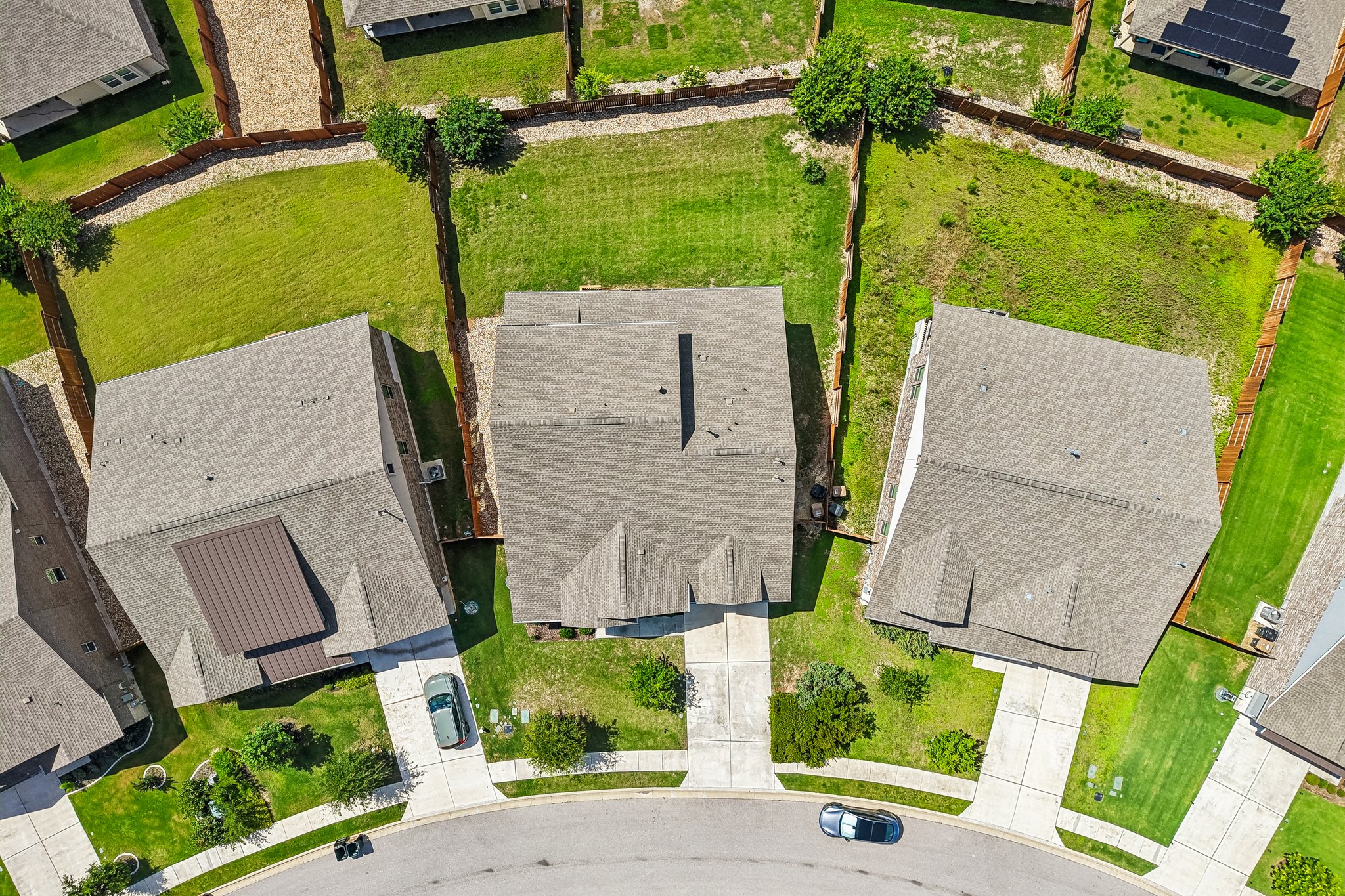 19113 Freeman Circle Austin, TX 78738 - Photo 30 of 37 An aerial perspective reveals neatly fenced yards bordering a quiet cul-de-sac with well-maintained homes.