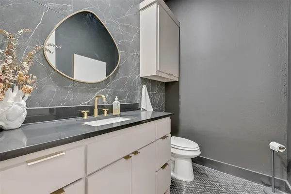 a bathroom with a toilet sink and mirror
