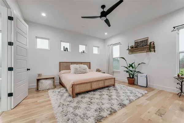 a bedroom with a large bed and a chandelier